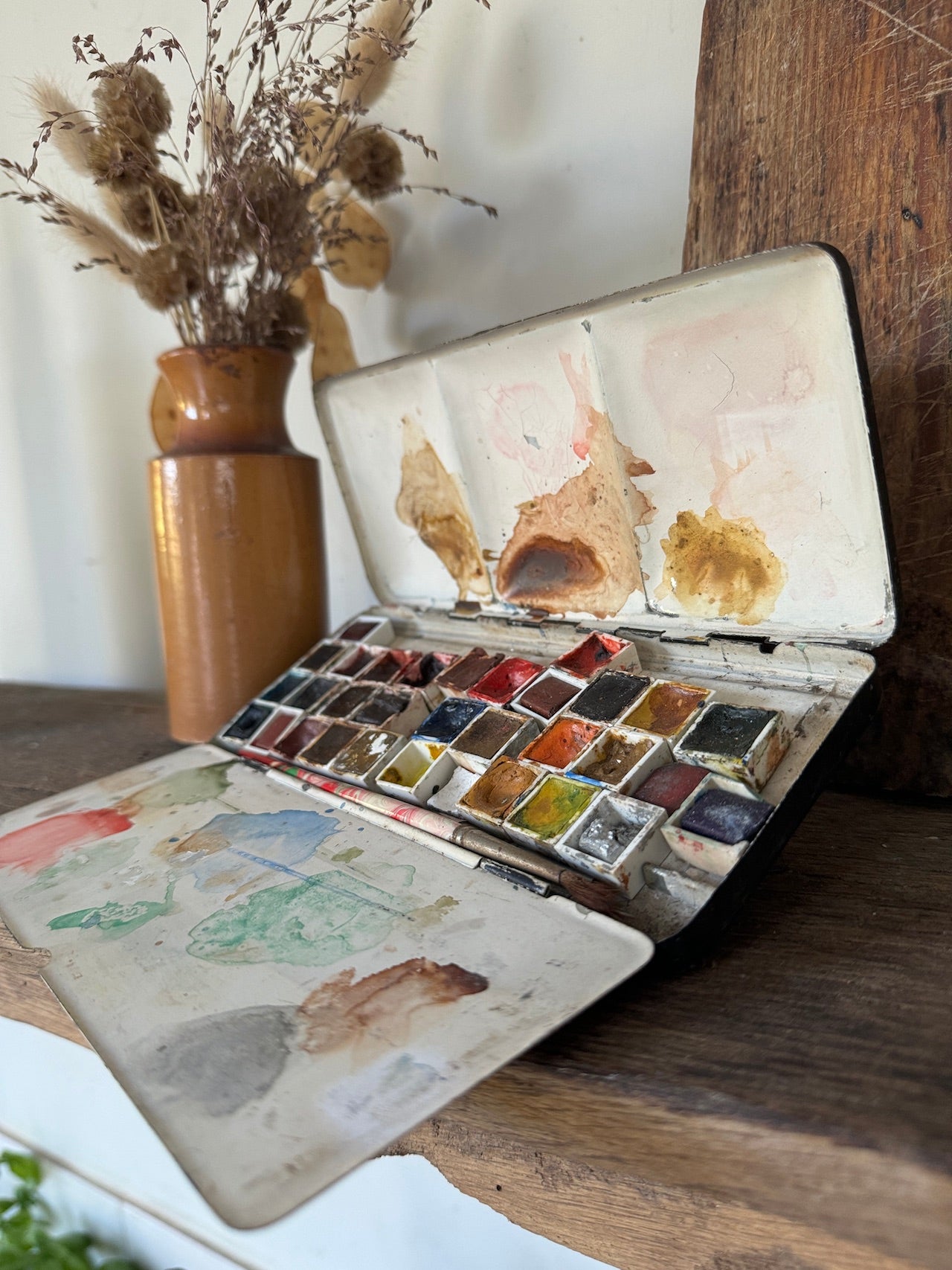 Vintage paint tin with paints and brushes