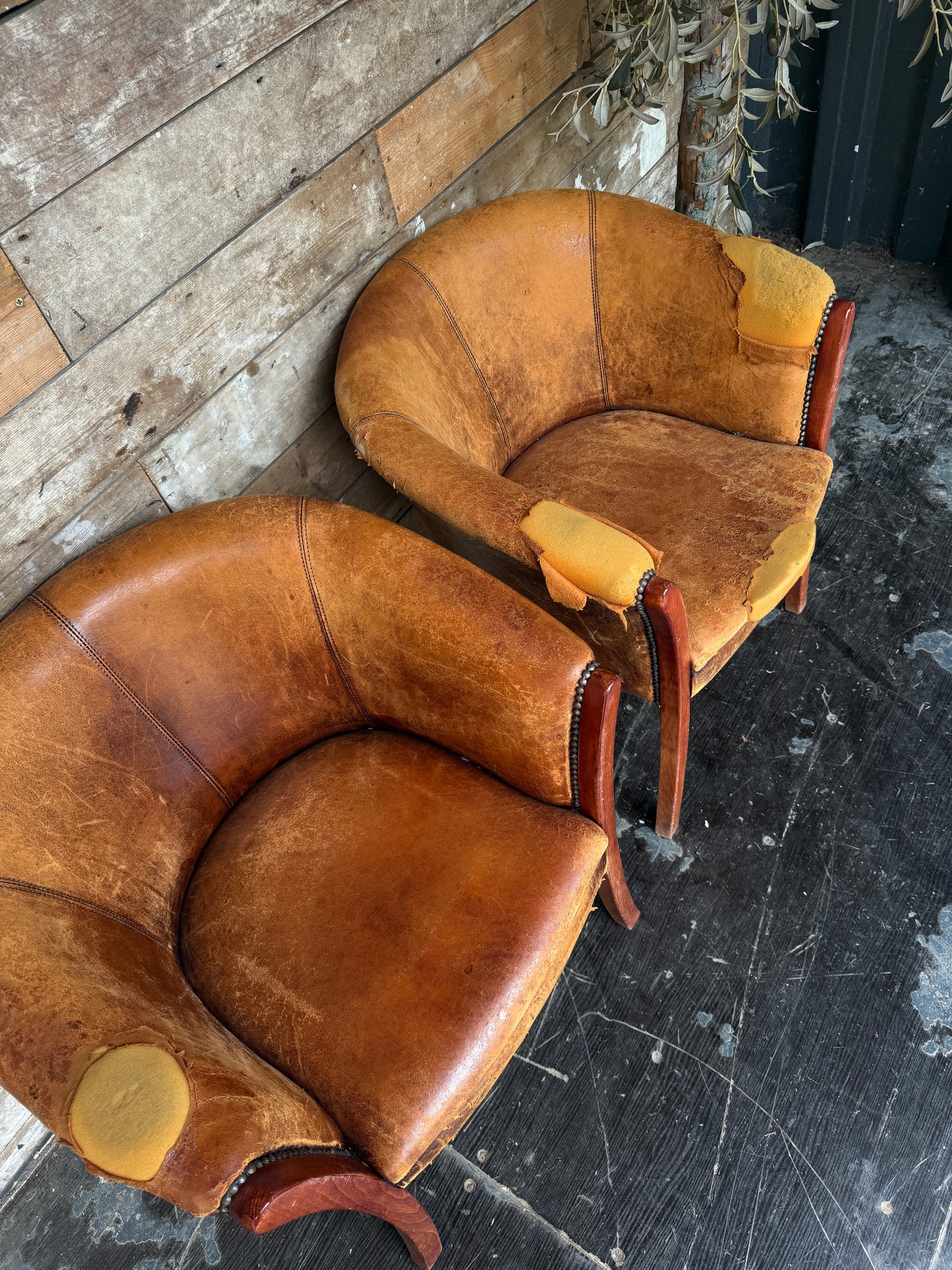 Pair of worn Dutch leather tub chairs