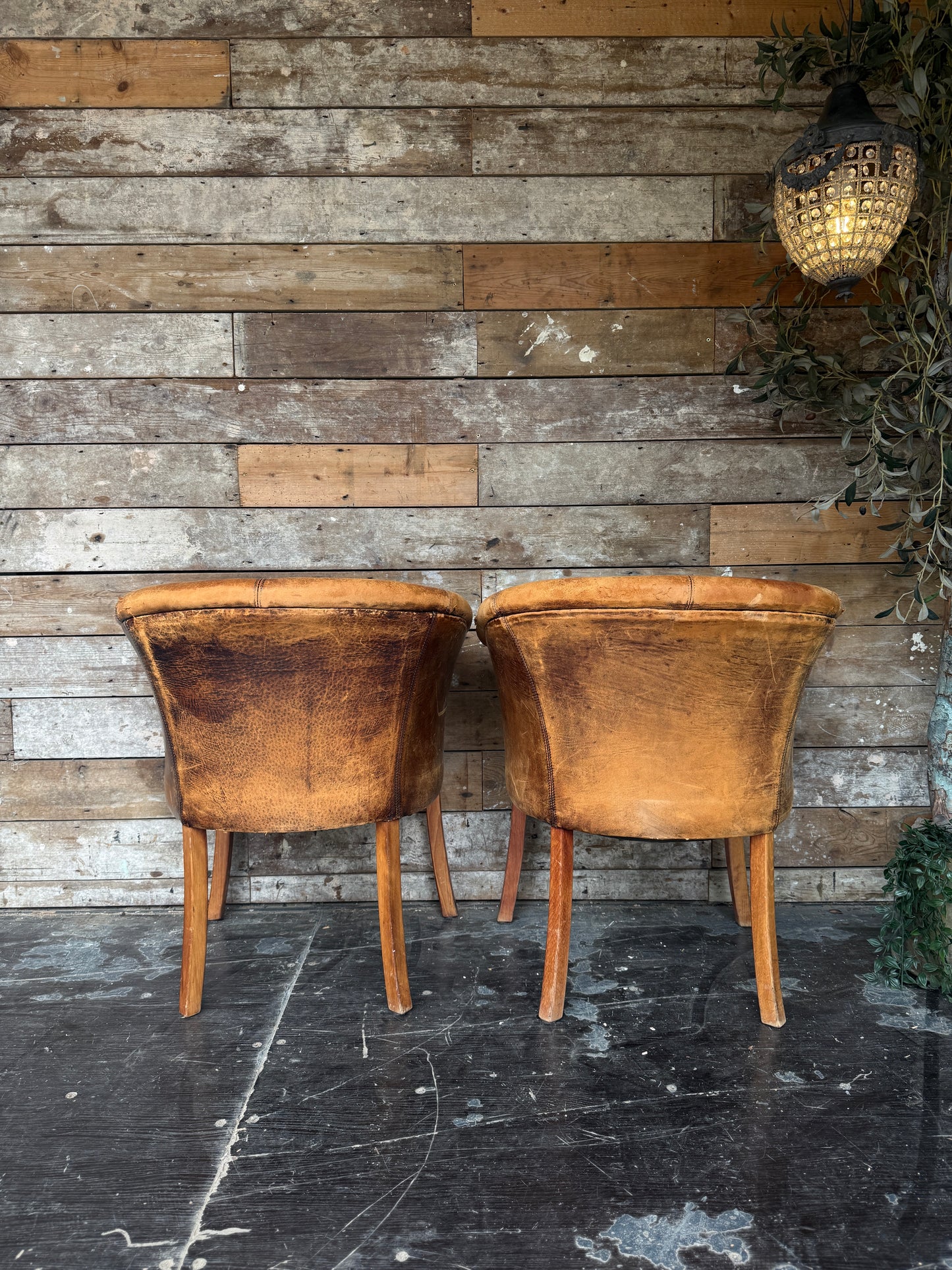 Pair of worn Dutch leather tub chairs